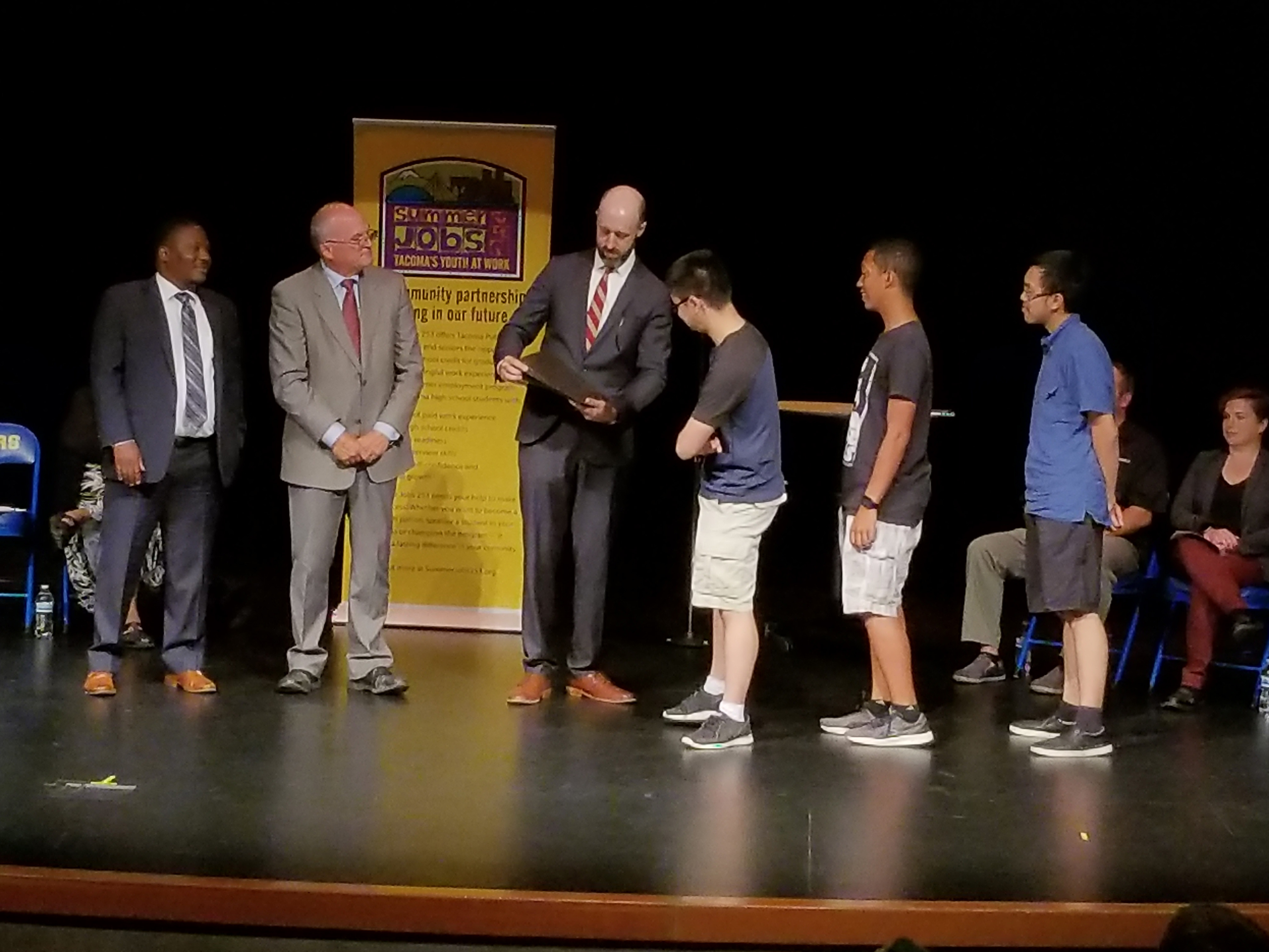 Students receive their certificates at the 2017 Summer Jobs 253 end-of-year event.