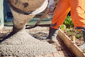 Concrete pouring during commercial concreting floors of building