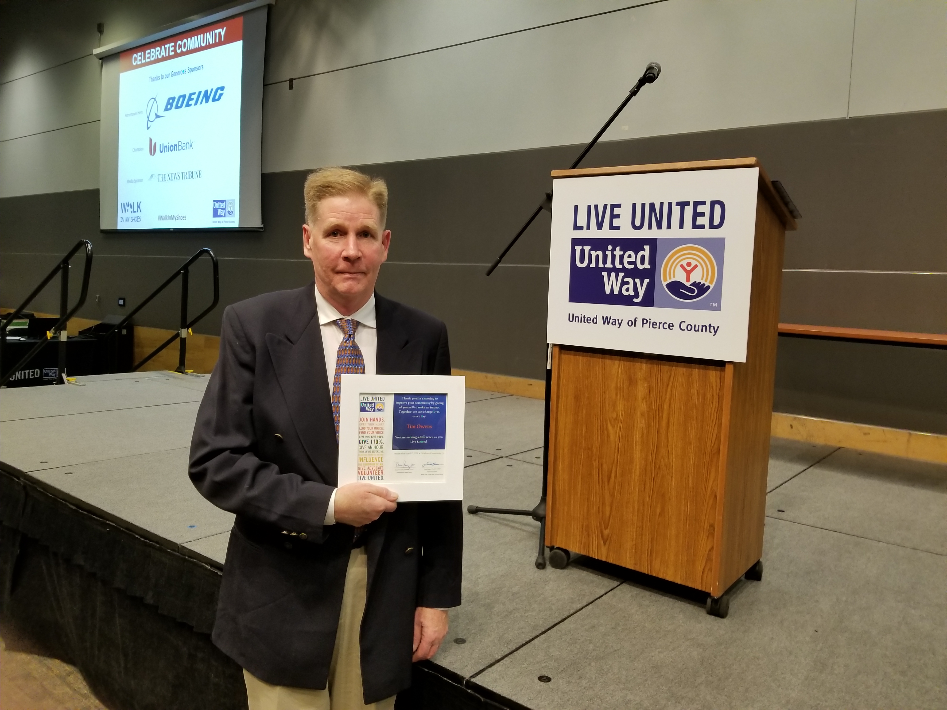 Pierce County WDC Chair Tim Owens poses with his LIVE UNITED award on April 17, 2018.