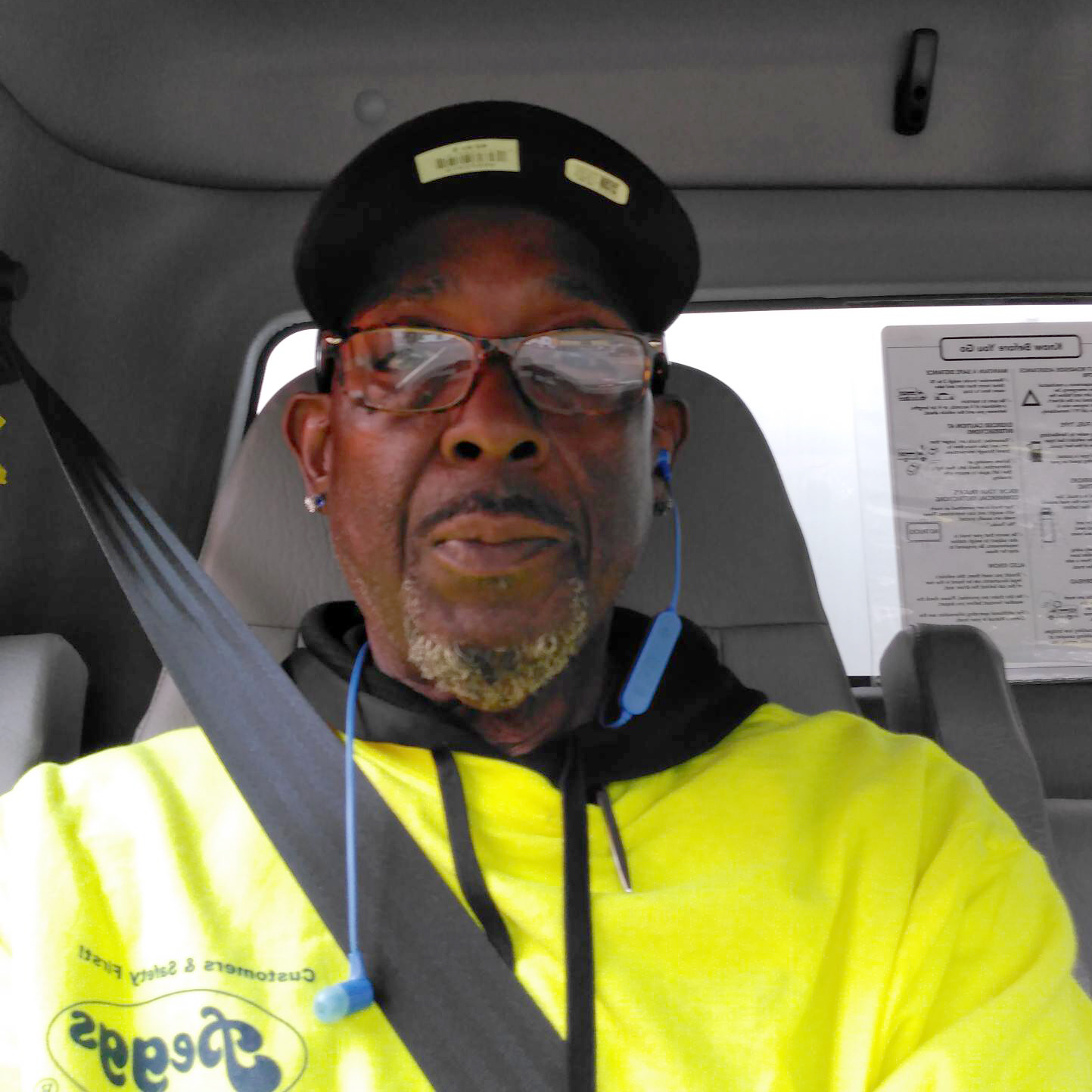 Anthony a WorkSource customer smiling and sitting in vehicle with seatbelt on
